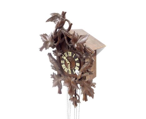 Black Forest triple weight and double cuckoo wall clock, the 6" dial within a chalet case with applied foliate and bird carve