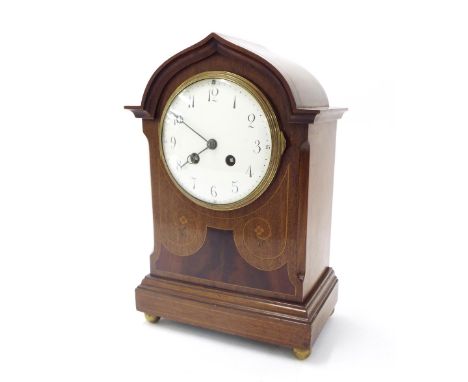 Mahogany two train mantel clock striking on a gong, the 4.75" white dial within an inlaid stepped case surmounted by a moulde