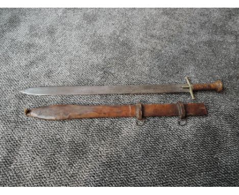 A Sudanese Sword (kaskara) possibly 19th century with flat double edge blade, heavily etched, cruciform hilt, leather grip, b