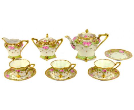 A NORITAKE TEA SERVICE, PAINTED WITH PINK FLOWERS IN APPLE GREEN AND RAISED GILT BORDERS