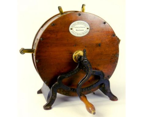 A LATE VICTORIAN OR EDWARDIAN IRON, BRASS AND VARNISHED WOOD KNIFE CLEANING MACHINE, WITH ENAMEL TRADE TABLE OF THOMAS BRADFO