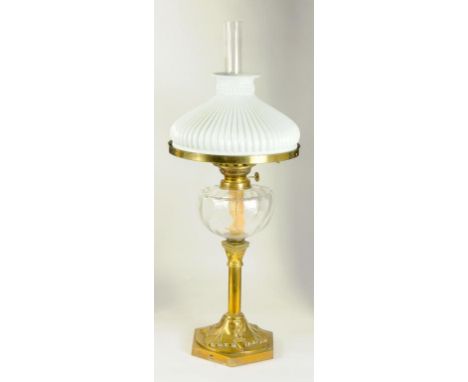 A VICTORIAN BRASS OIL LAMP, THE FOOT EMBOSSED WITH OAK LEAVES AND ACORNS, GLASS FOUNT,WITH WHITE GLASS SHADE
