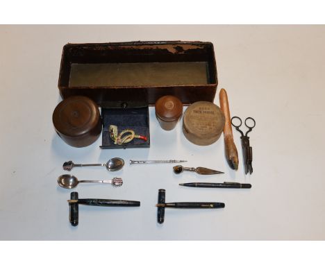 A box containing various treen items; pen knife; two white metal spoons; fountain pens; propelling pencil; pipe etc.