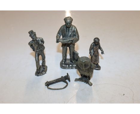 A collection of white metal figures and a model owl