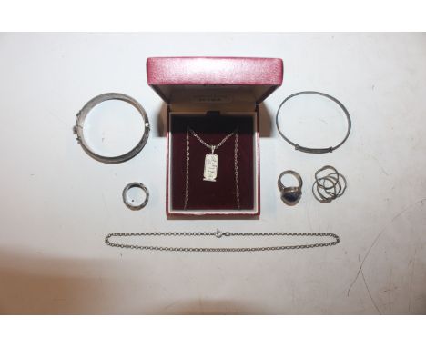 A white metal bangle; a white metal snap bangle; and a collection of white metal and silver jewellery to include rings and ne