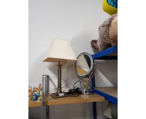 A TABLE LAMP WITH COLUMN DESIGN AND A SHAVING MIRROR