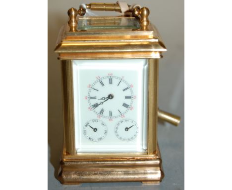 A lacquered brass cased minuet carriage clock, having main dial over subsidiary day and date dials, late 20th century, h.8cm.
