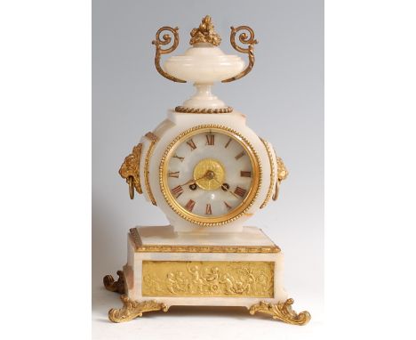 A 19th century onyx and gilt metal mounted mantel clock, the case surmounted with a pedestal urn and having lion mask and rin