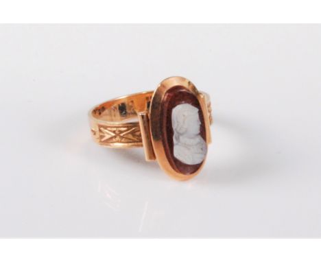 A 14ct gold cameo ring, the oval shell cameo of a lady, collet mounted with closed back, 15mm long, with half engraved should