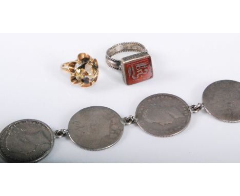 A 9ct citrine ring, size H, (3.6g), a carnelian intaglio ring in unmarked white metal and a mixed coin bracelet, (3)