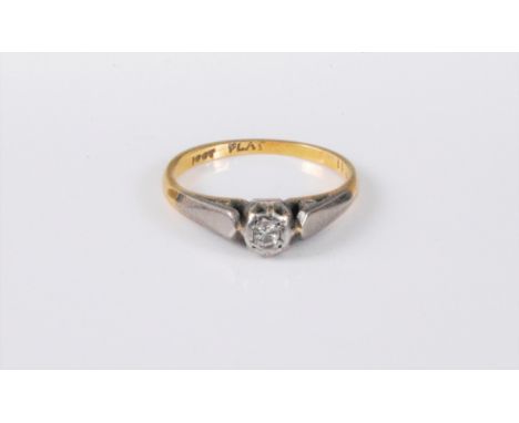 An 18ct and platinum diamond solitaire ring, the round brilliant cut diamond, estimated approx. 0.05cts, illusion set in plat