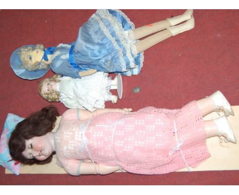 An early 20th century German bisque headed doll; together with another collectors doll on stand, and an early 20th century fe
