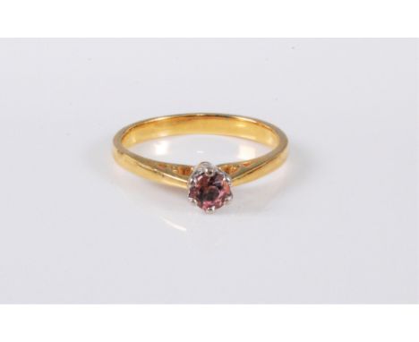 An 18ct gold pink tourmaline solitaire ring, the round pink tourmaline, approx. 4.3mm diameter, claw mounted to plain band ha