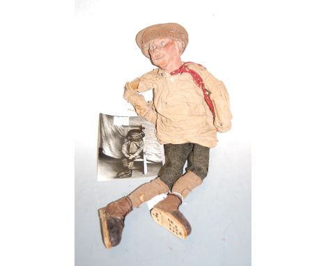 A mid 20th century carved wooden puppet in the form of a man with jointed body with photograph of said puppet with sign "Pupp