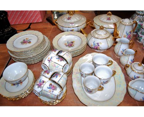 An early 20th century Czechoslovakian dinner/tea service on a white ground with floral decoration within lustre border, heigh
