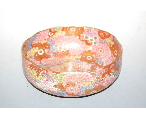 A Japanese Meiji period satsuma bowl, enamel decorated with flowers and foliage in bright colours and heightened in gilt, sig