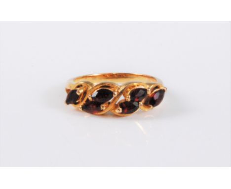 A garnet ring, the the six marquise cut garnets, all claw set to a plain unmarked band (tests as approx. 14ct gold), size M-N