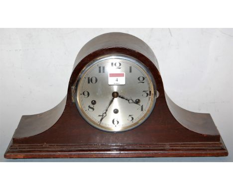 A 1920s mahogany cased mantel clock, having a silvered dial with Arabic numerals, and chiming movement