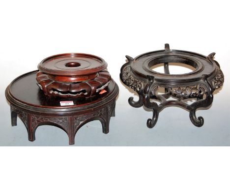 An early 20th century Chinese hardwood jardinière stand, of circular form, the fret carved frieze with floral decoration, on 