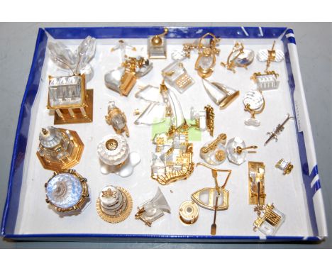 A collection of principally Swarovski cut crystal ornaments, some with gilt metal mounts to include rocking horse, lantern, g