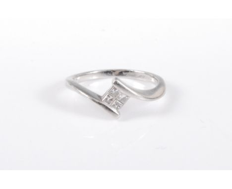 A platinum diamond ring, the four princess cut diamonds, estimated approx. 0.15cts, in a crossover style band, stamped with C