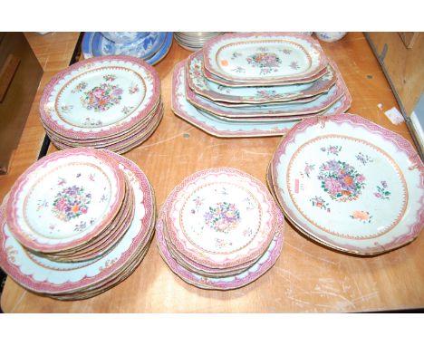 A 19th century Chinse export tin glazed part dinner service, enamel decorated with roses within a raised pink border, heighte