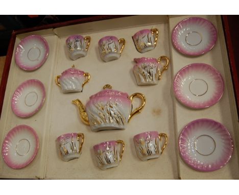 A cased Continental childs porcelain tea service. Some small losses, mainly to bases.