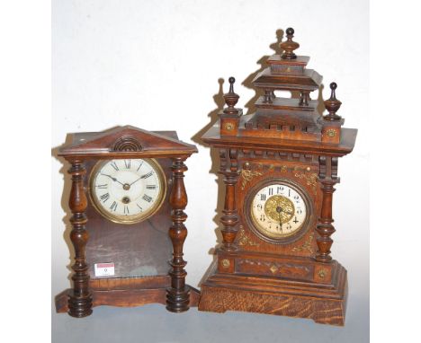 A late 19th century Continental oak cased mantel clock, having painted dial with Arabic numerals, h.45cm; together with one o