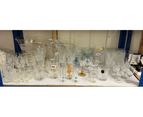 A shelf of drinking glasses, An ice bucket &amp; a jug