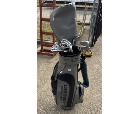 A quantity of Evolution golf clubs in a bag COLLECT ONLY