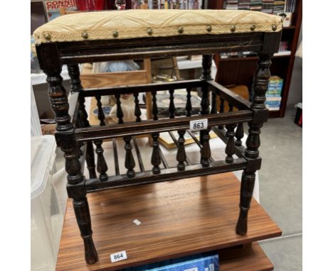 An Edwardian piano stool with music book shelf