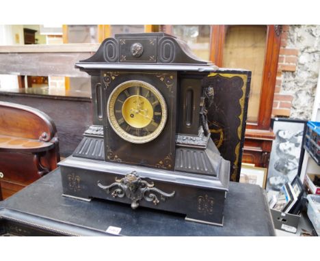 A large Victorian slate mantel clock,&nbsp;46.5cm high, with pendulum, (chips). 