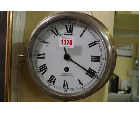 A Smith's brass bulkhead timepiece, with enamel dial, 23cm diameter. 