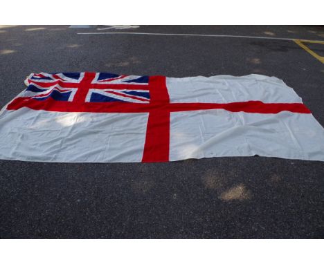 A large white ensign flag,&nbsp;with broad arrow stamp, 180 x 370cm; together with an Australian flag, 86 x 182cm 