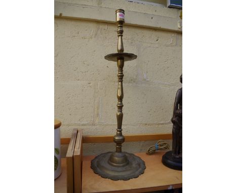 A large antique Continental brass candlestick,&nbsp;70cm high. 
