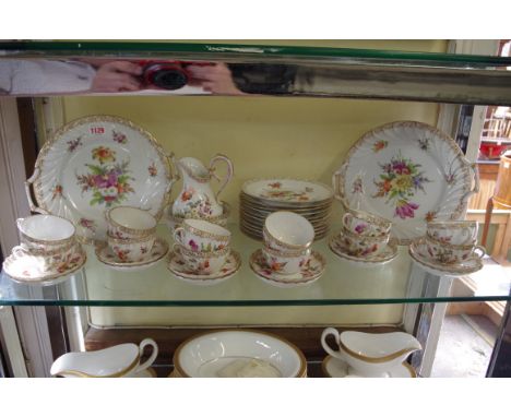 A Dresden floral painted porcelain part tea service,&nbsp;comprising: a pair of twin handled plates, 27.5cm wide; a cream jug