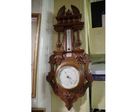 An antique French carved beech aneroid wheel barometer,&nbsp;69cm high.&nbsp; 