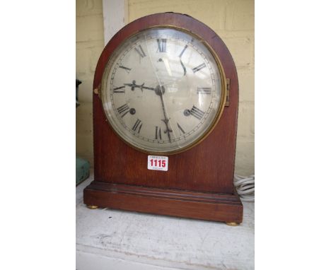 An Edwardian mahogany and inlaid dome top mantel clock, 29.5cm high; together with an oak aneroid wheel barometer. 