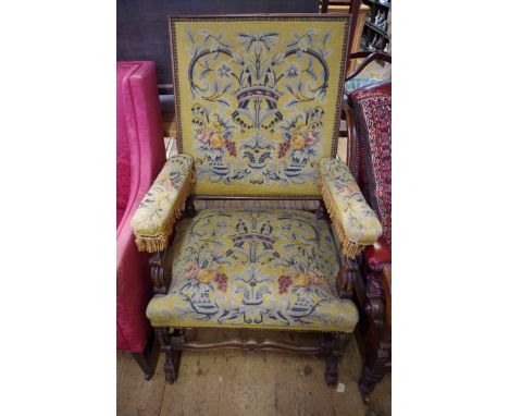 An antique 17th century style, carved walnut, beech and tapestry upholstered open arm chair.&nbsp; 