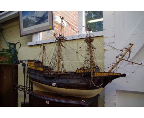An old painted wood model galleon, the hull 93cm long. 