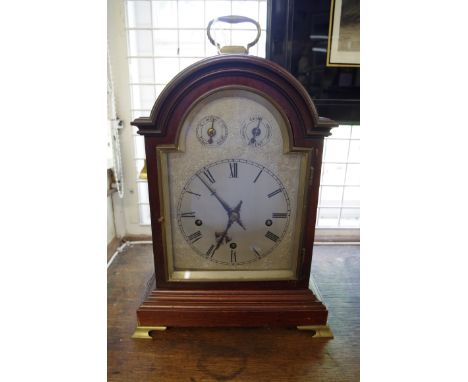 An early 20th century mahogany musical mantel clock,&nbsp;with arched silvered dial, striking on five straight gongs and with