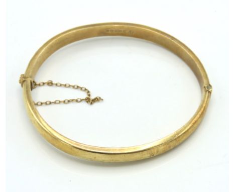 A 9ct gold bangle, internal measurement 62mm x 52mm, 9.3g