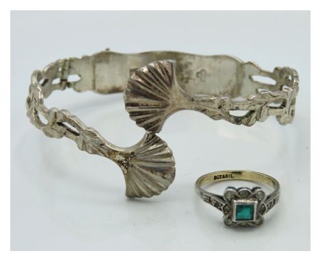 A converted hallmarked silver pair of tongs as a bangle, hinged, 23.1g twinned with a 9ct gold & silver ring set with green s