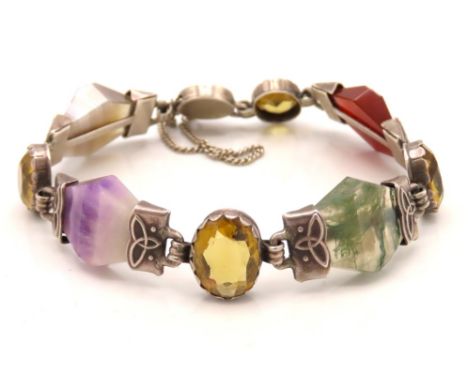 A Celtic style bracelet set with quartz, amethyst, carnelian & agate stones in white metal mounts, 24g