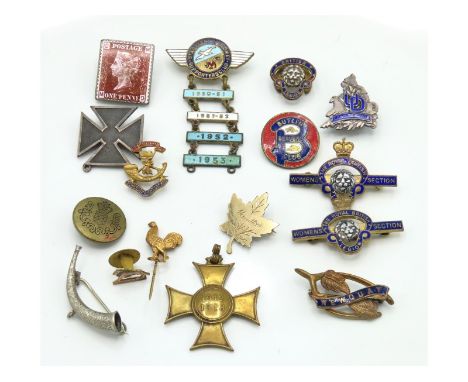 A St. Austell Speedway enamel badge set, a silver cross, a white metal horn brooch, a Butlin's Beaver club, a Newquay brooch 