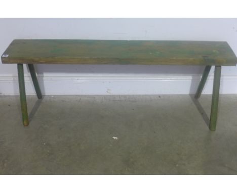 A small 19th century green painted waxed pine bench on stick legs - Width 131cm 