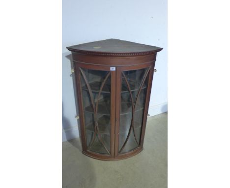 A 19th century mahogany bow fronted corner cabinet with twin astragal doors, shelved interior on a shaped base - 100cm x 64cm