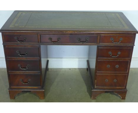 A Georgian style mahogany twin pedestal desk with leather inset over an arrangement of nine drawers on bracket feet - 78cm x 