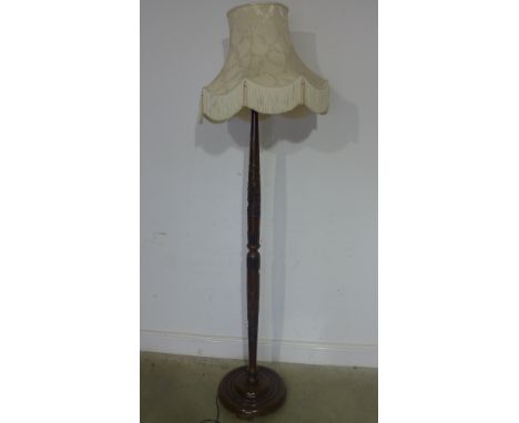 A 1950's standard lamp with carved column and attractive shade