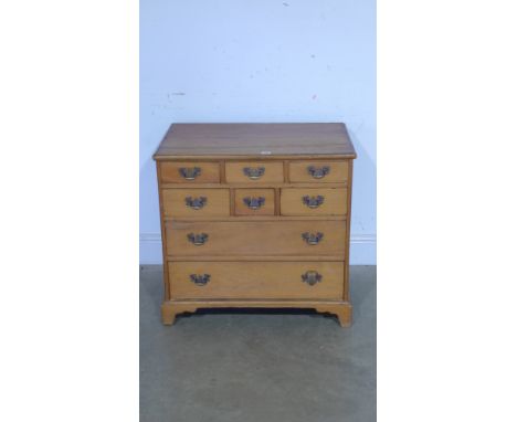 A 19th century pine chest of six small and two long graduated drawers with brass drop handles on bracket feet - 70cm x 73cm x